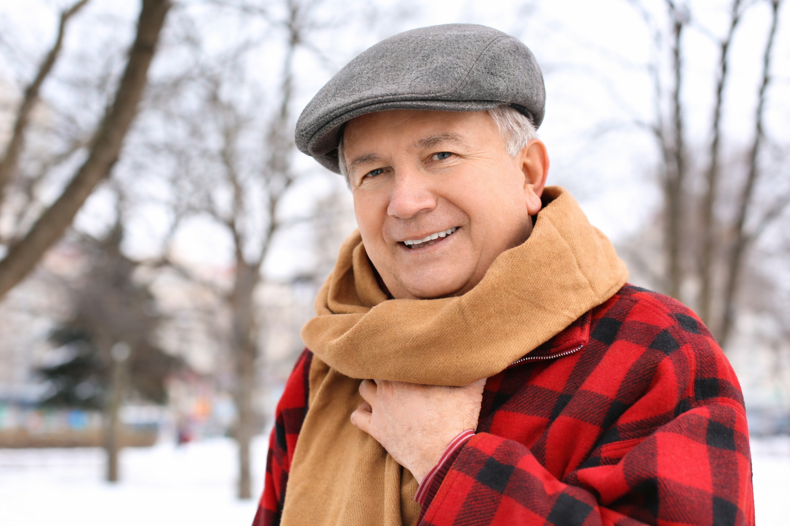 Man wearing a winter hat and scarf, promoting Winter Hats collection.
