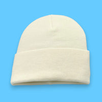 Cream Knit Hat on blue background